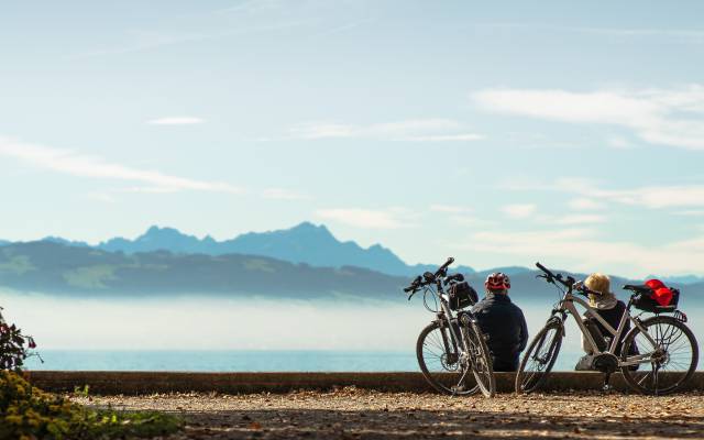 Fahrradfahrer sitzen am Ufer des Bodensees